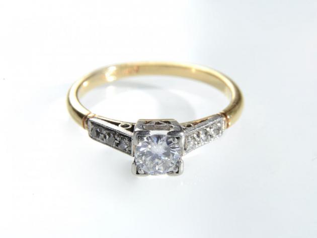 Art Deco diamond flanked solitaire in platinum and gold