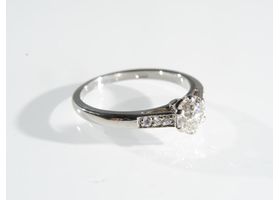 Platinum diamond flanked solitaire ring