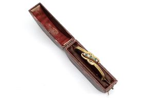 Antique diamond and emerald twist bangle in yellow gold