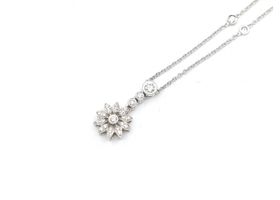 Dainty diamond set flower necklace with spectacle set diamonds