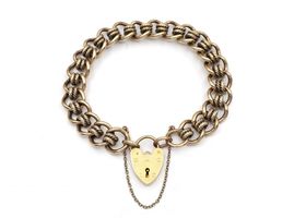 1987 solid yellow gold curb bracelet with heart lock