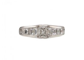 Rectangular diamond flanked solitaire engagement ring in platinum